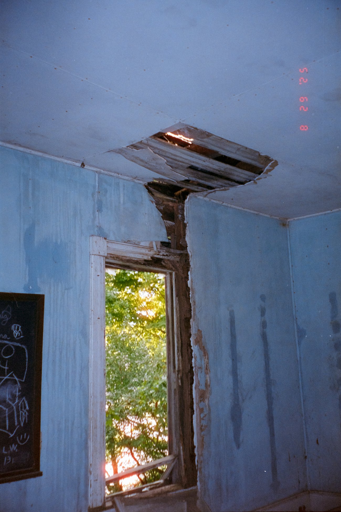 A room with water damage to the ceiling and walls