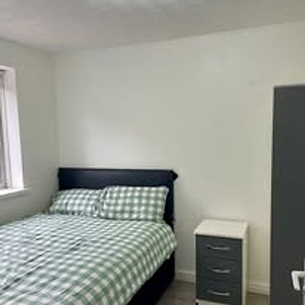 Furnished bedroom with double bed and bedside drawers