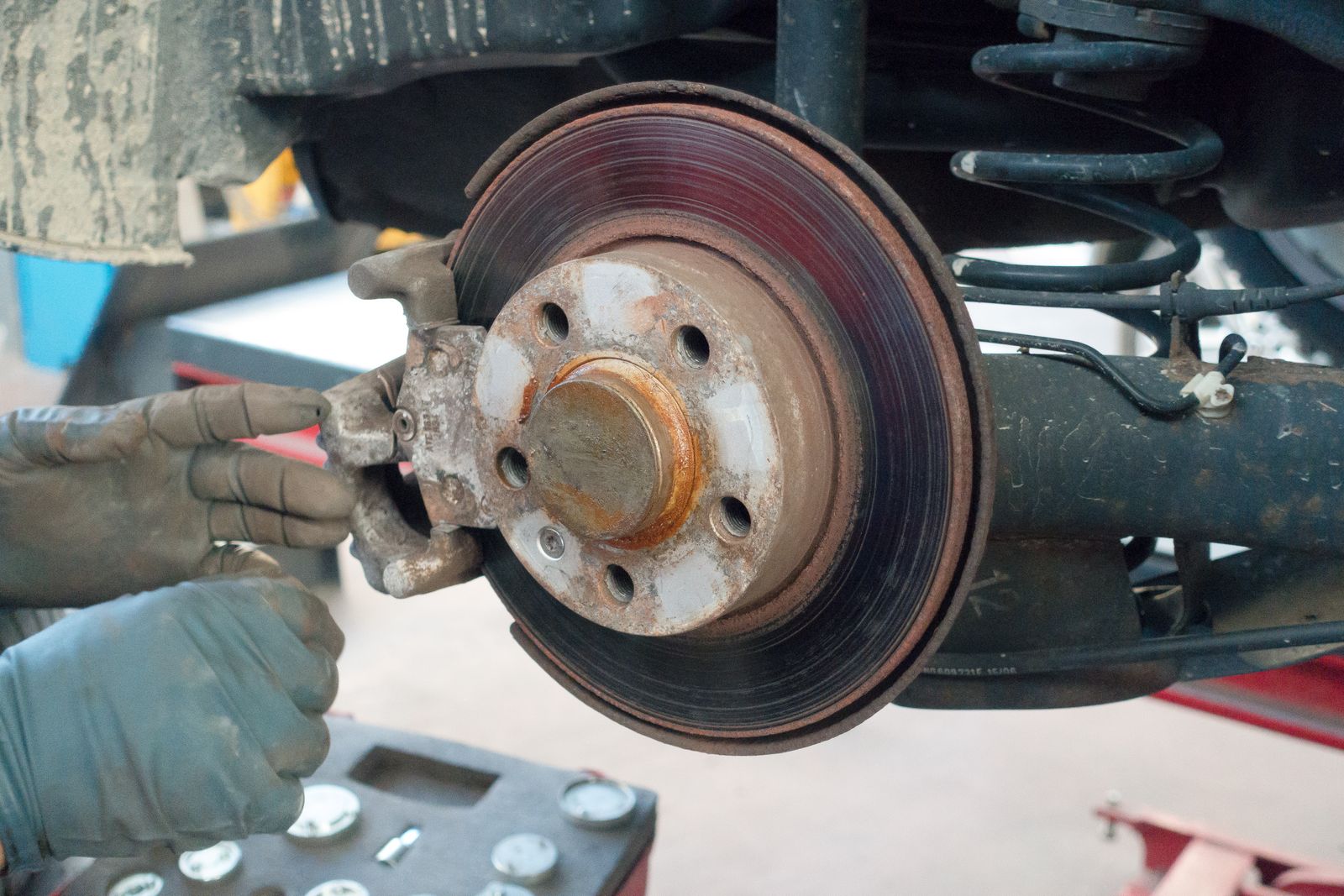 A worn brake disc and hub exposed with the wheel removed
